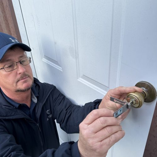 Emergency locksmith in Winchester VA unlocking residential door with precision lock pick tools.