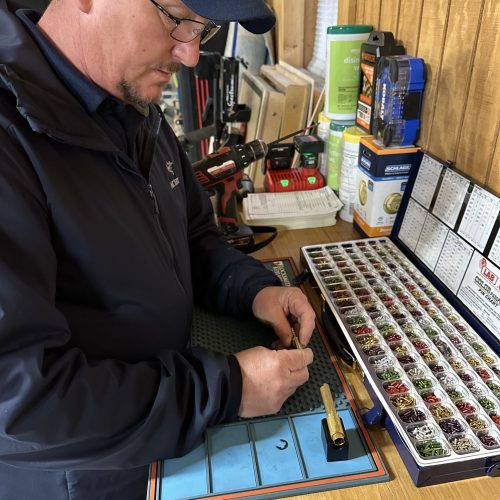 Locksmith in Winchester VA rekeying a residential lock using a pinning kit and professional tools.