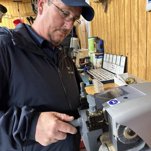 Precision Lock & Key locksmith performing expert key duplication in Winchester VA workshop.