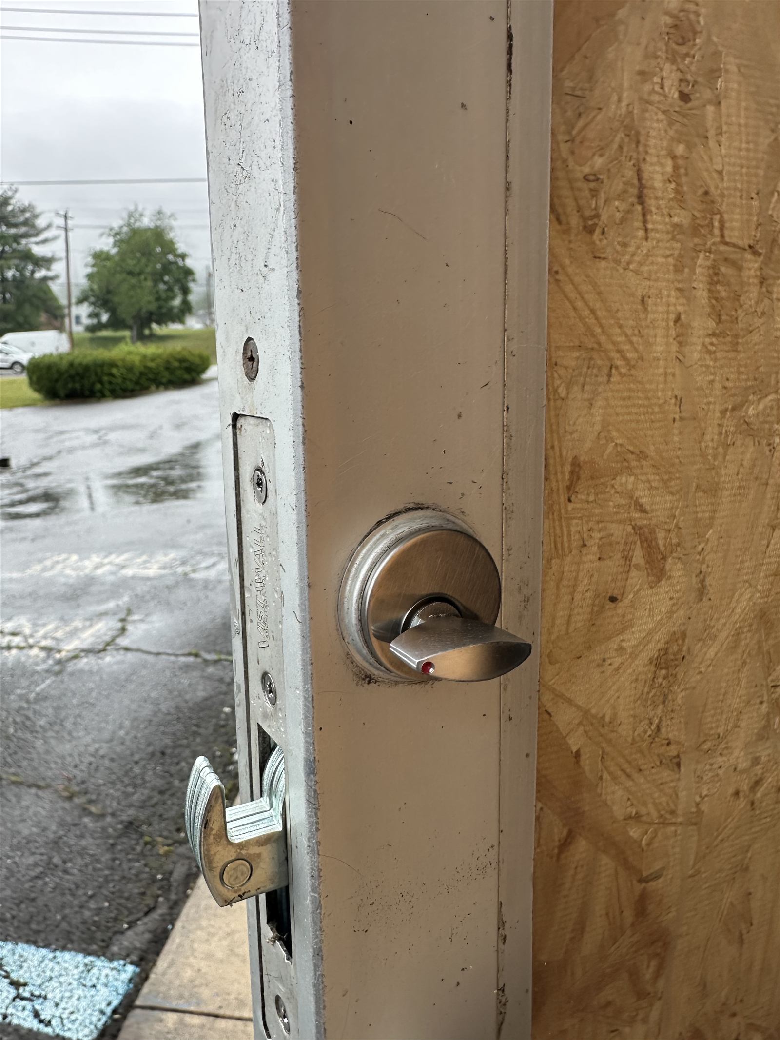 Deadbolt thumb turn lock installed on an aluminum storefront door in Winchester VA